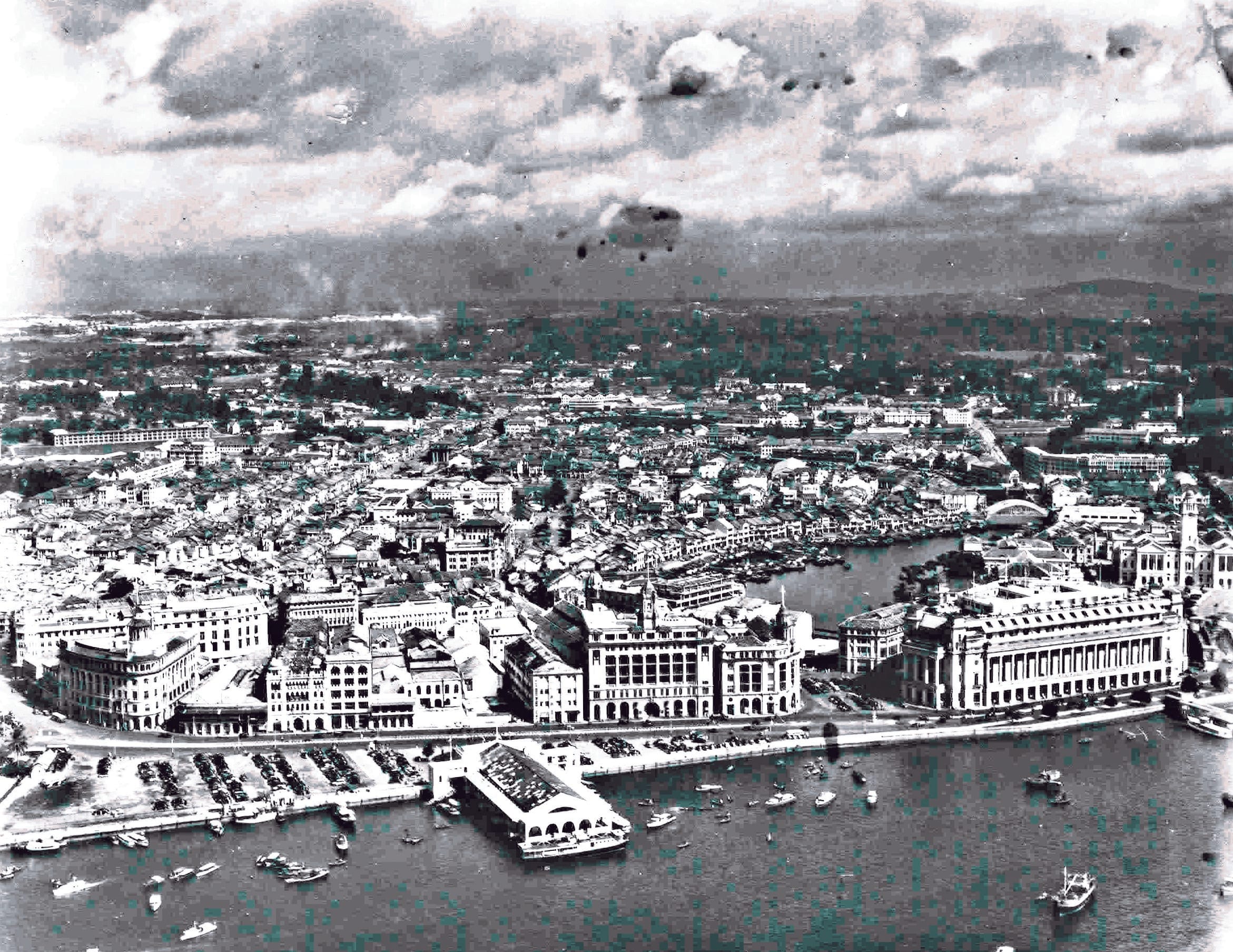View of the waterfront buildings at the city-centre which include Clifford Pier, Fullerton Building, Victoria Memorial Hall, Hongkong and Shanghai Bank, Union Building and Ocean Building. Copyright Williams-Hunt Collection, SOAS.